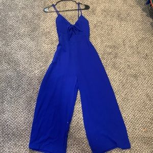 Royal blue crop jumpsuit with tie top detail. SIZE L.